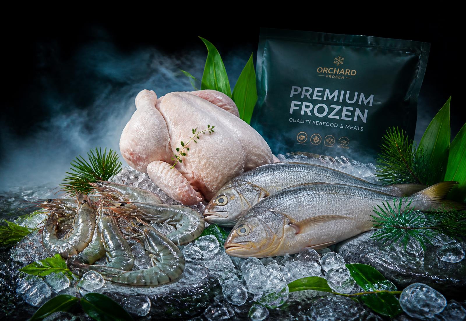 Frozen chicken, prawns and croaker fish displayed on crushed ice
